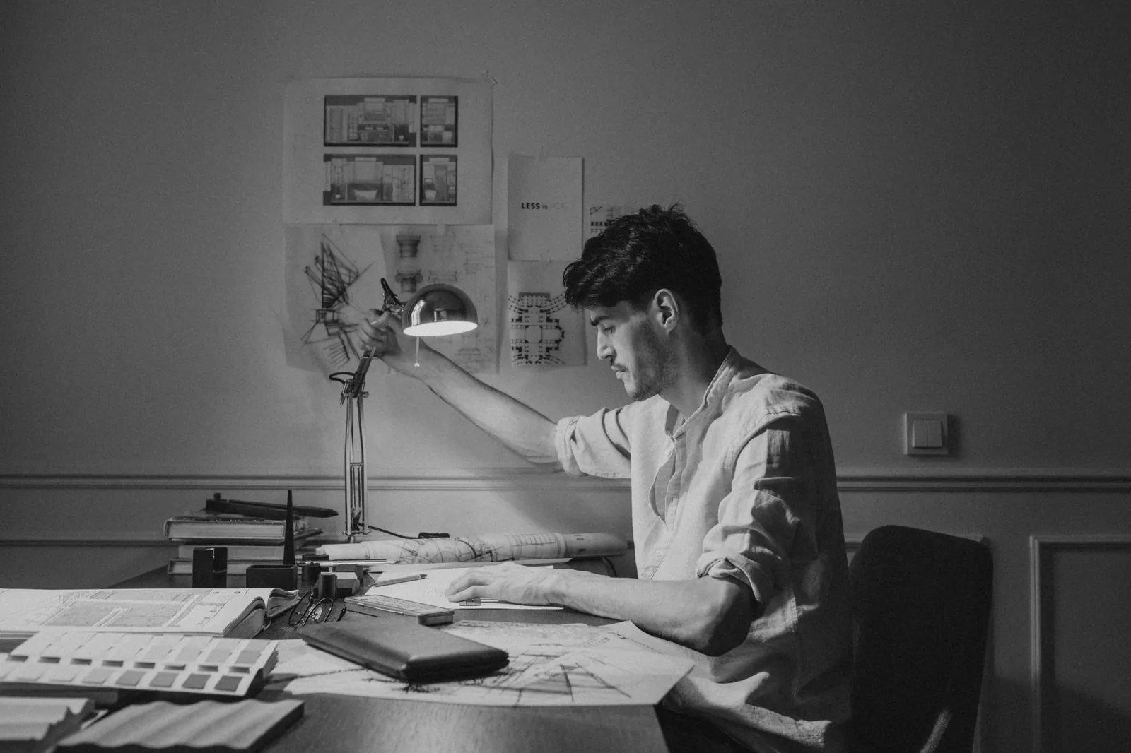 An architect drawing at the studio table