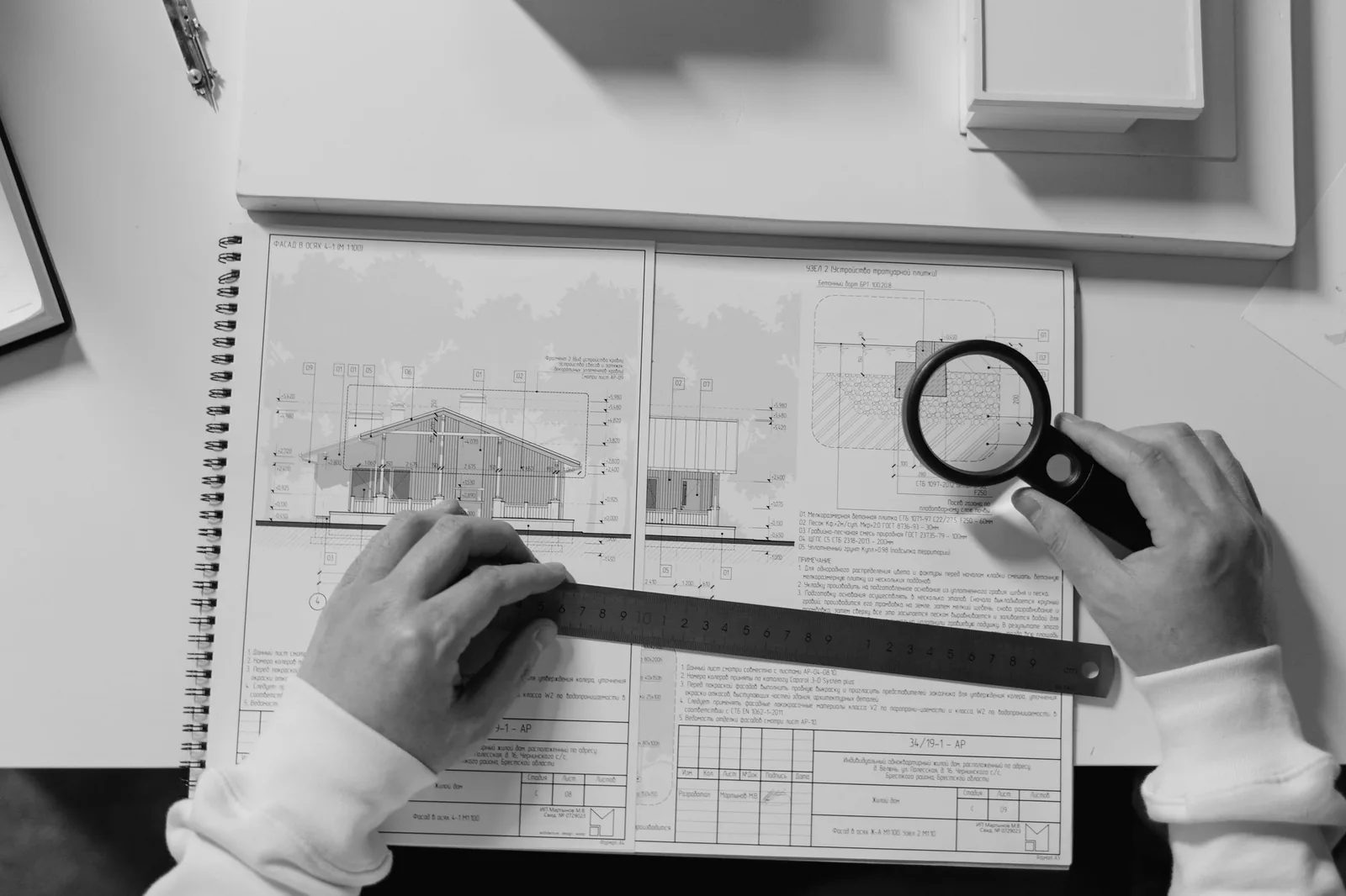 Hands measuring a plan